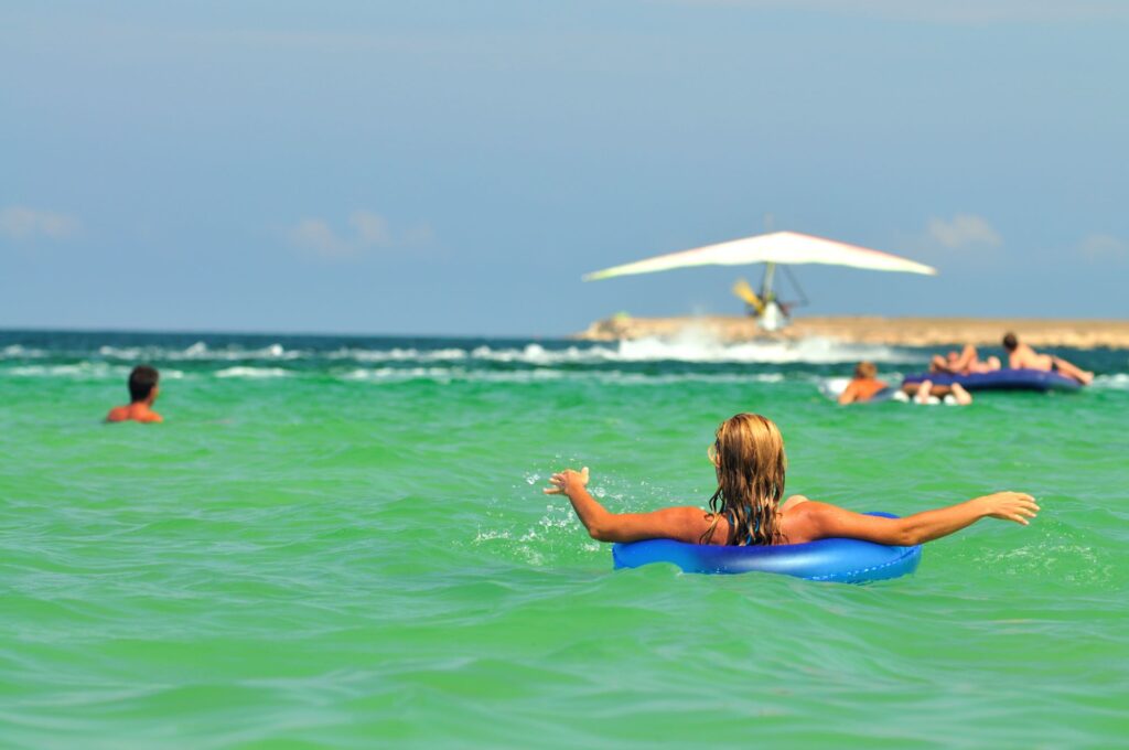 Girl in floaty at the beach