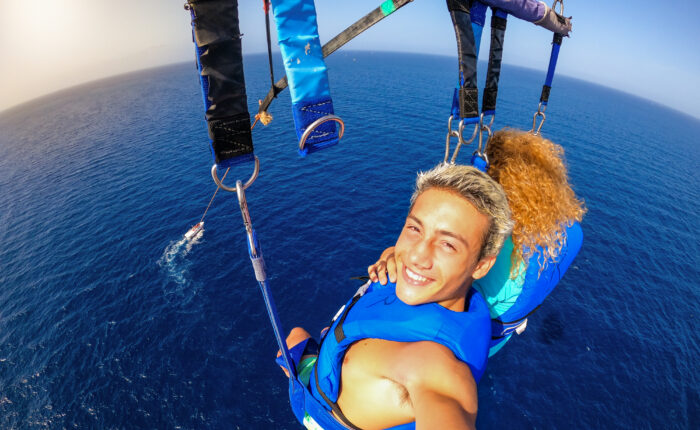 a couple enjoying a day of parasailing
