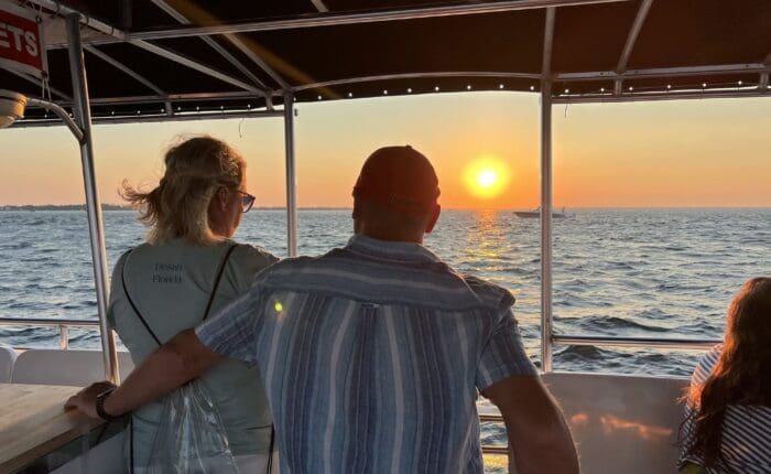Couple watching the sunset from the boat on a Destin sunset dolphin cruise